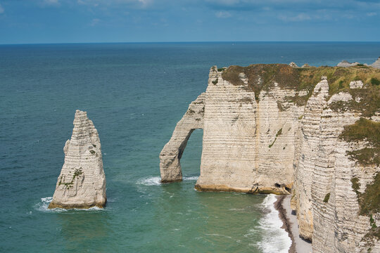 Famous Needle Rock and Porte d'Aval natural arch at Etretat cliffs in Normandy, France