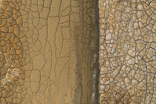 Aerial view of the cracked and desiccated clay surface of Gora Bokty, showcasing intricate geometric patterns in the arid landscape of Karakiya District, Mangystau Region, Kazakhstan.