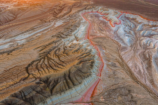 Aerial view of Gora Bokty featuring colorful striped sedimentary rock formations, eroded gullies, and desert landscape in Karakiya District, Mangystau Region, Kazakhstan.