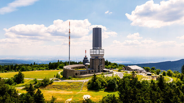 Aerial view of the Grosser Feldberg summit with its iconic telecommunications tower, surrounding forest, and rolling hills in the Taunus mountain range, Schmitten im Taunus, Hessen, Germany.