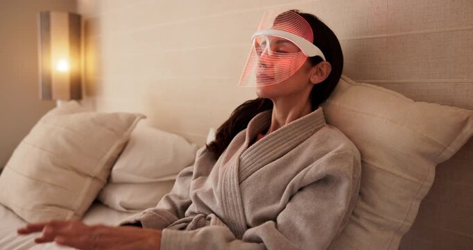 Skincare, woman and mask for red light therapy, boost collagen and anti aging benefits in bedroom. Mature person, beauty and infrared LED for facial treatment, biohacking and dermatology glow in home
