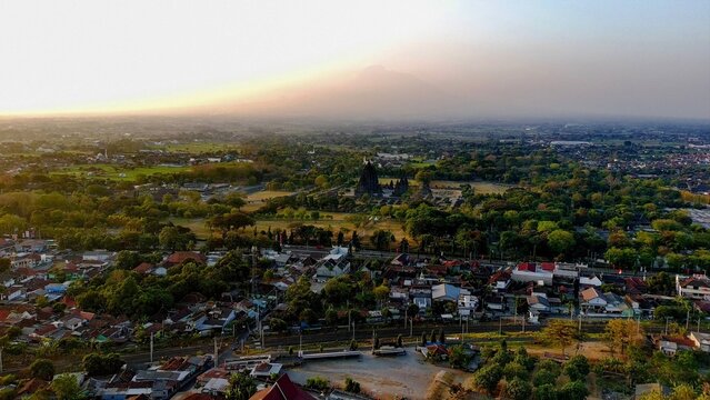 Aerial view of the historic Prambanan temple complex surrounded by lush greenery and the town of Prambanan, Special Region of Yogyakarta, Indonesia.