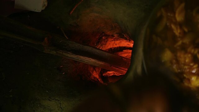 Raw mango pickle made with sugarcane molasses in a pot on a wood-burning mud stove in West Bengal, making raw mango pickle (Kacha Amer Achar) is a cultural ritual that signals. Sweet & Sour Raw Mango 