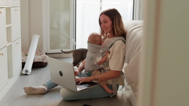 Working mother multitasking with newborn and pet