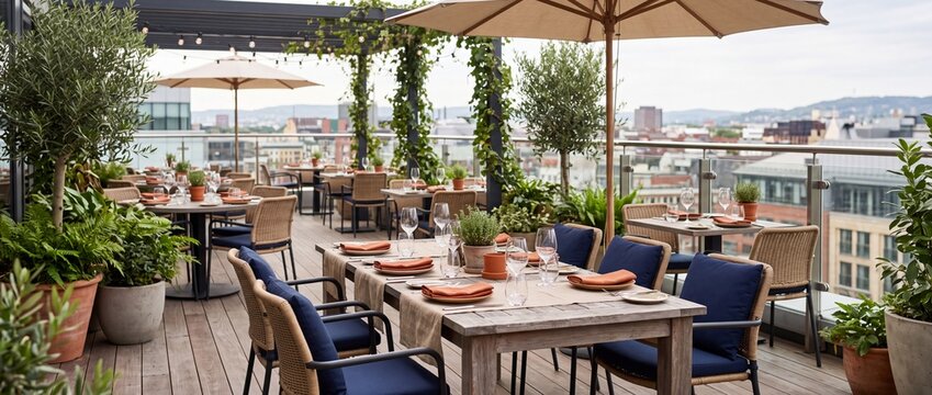 Rooftop restaurant dining terrace with set tables and umbrellas. Outdoor patio cafe with plants overlooking city skyline