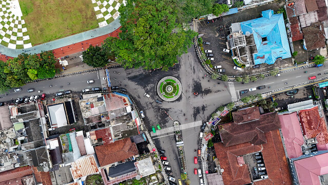 Aerial view of Taman Kota Lapang Merdeka Sukabumi showing the central roundabout intersection with surrounding urban buildings, rooftops, and traffic, Sukabumi, West Java, Indonesia.