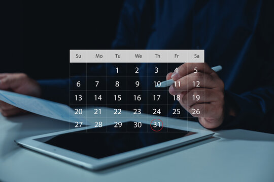 Business professional using a digital calendar on tablet with stylus, showing schedule planning, appointment management, monthly deadlines, time organization, productivity, and business workflow.