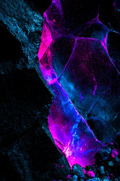 Editorial fashion background with fractured crystal cavern and neon mineral glow copy space