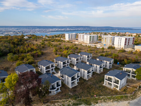 Aerial view of a modern cottage village near the sea and forest