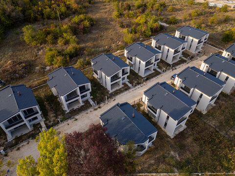 Aerial view of a modern cottage village near the sea and forest