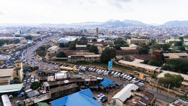 Aerial view of Terminus Jos, a bustling urban area with busy roads, parked vehicles, and surrounding buildings in Jos, Plateau, Nigeria.