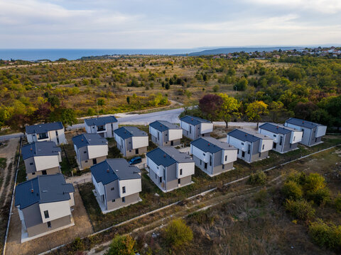 Aerial view of a modern cottage village near the sea and forest