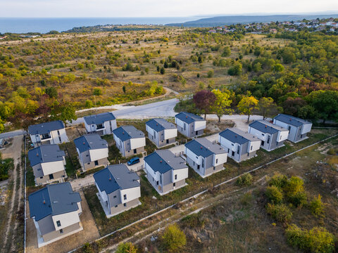 Aerial view of a modern cottage village near the sea and forest