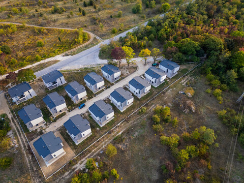 Aerial view of a modern cottage village near the sea and forest