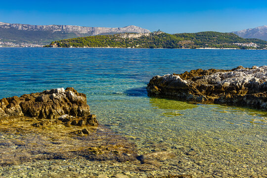 Empty Acida Beach with panoramic views of Marjan, Split and Kastela