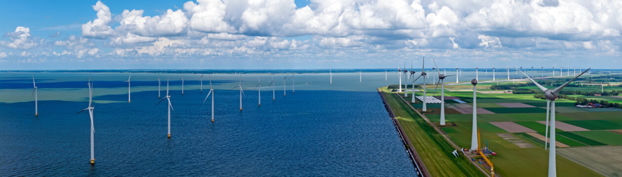 Panoramic view of wind turbines on a large inland lake in Europe..Description: