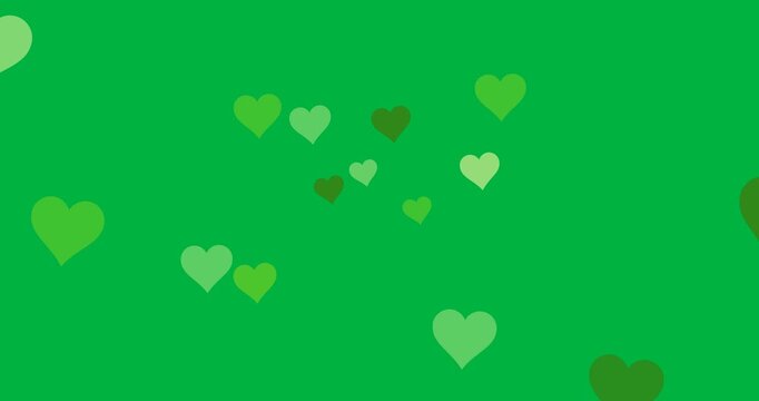 Digital animation of multiple green hearts icons floating against black background