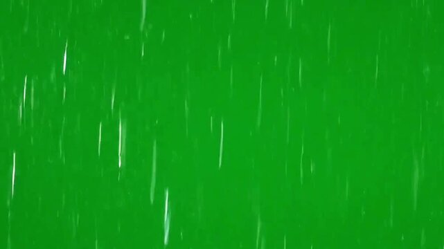 Heavy rainfall dropping down vertically against bright green chroma key background video footage