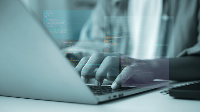 Hands of professional programmer typing on laptop with source code screen overlay. software development. web engineering. cybersecurity. and coding technology concept.
