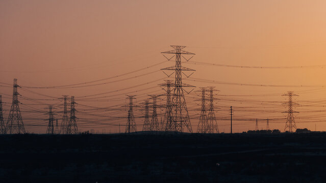 High Voltage Electric Line Transmission Towers and Power Lines in Desert Landscape of Saudi Arabia