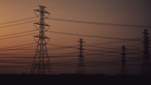 High Voltage Electric Line Transmission Towers and Power Lines in Desert Landscape of Saudi Arabia