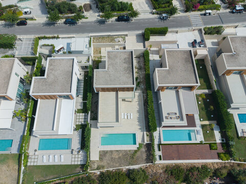 Aerial view of modern villas with private swimming pools and landscaped gardens at Green Coast in Palase, Qarku i Vlores, Albania.
