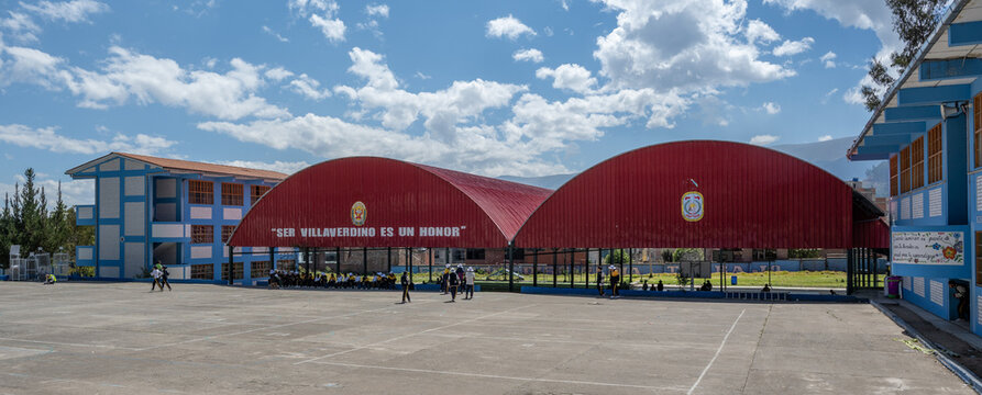 Huancayo, Peru &ndash; July 16, 2026: Students gather in the courtyard of the I.E. PNP Ramiro Villaverde Lazo, beneath covered school pavilions bearing the motto &ldquo;Ser Villaverdino es un honor.&rdquo; 