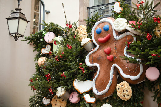 Christmas in Strasbourg, Alsace, France. Giant gingerbread man and festive holiday decorations on a historic street.
