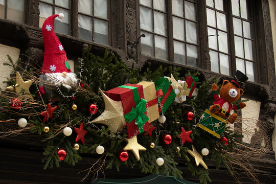 Christmas in Strasbourg, Alsace, France. Festive decorations with Santa gnome, teddy bear and colorful Christmas gifts.