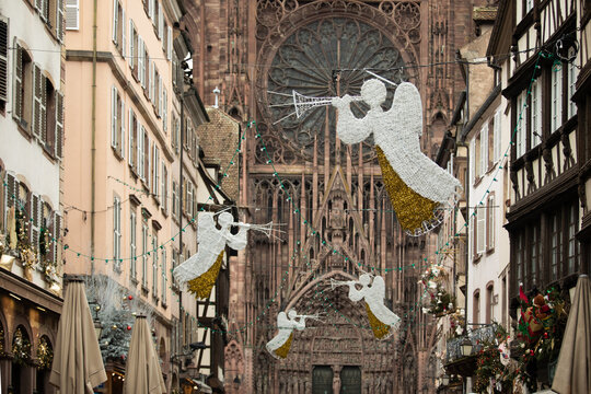 Christmas in Strasbourg, Alsace, France. Illuminated angels with trumpets above a historic street near Strasbourg Cathedral.