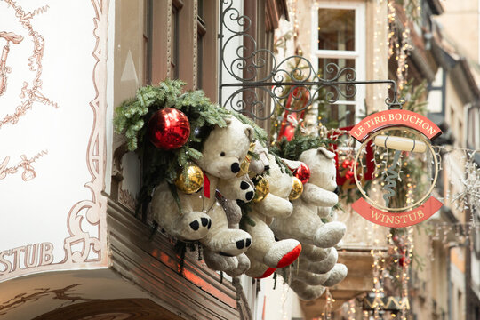 Strasbourg, France - December 24, 2025: Christmas teddy bear decorations on the famous Le Tire-Bouchon restaurant facade in Alsace