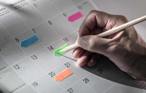 Calendar notes, timetable and event agenda planning schedule on coloured arrow flags
