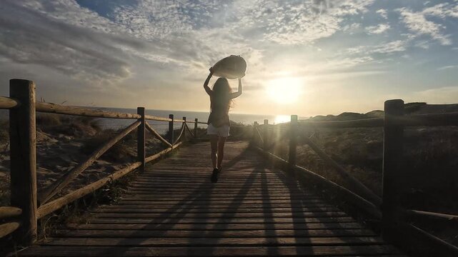 Female surfer running toward the beach with surfboard at sunset, dynamic summer adventure, passion for surfing, active outdoor lifestyle, ocean sports and adrenaline