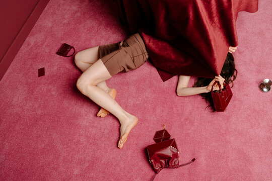 Red Fashion Scene With Hidden Handbag And Legs