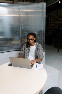 Creative professional working remotely on a laptop in a coworking