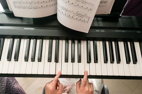 Child's fingers on a musical keyboard