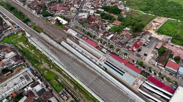 Aerial view of Stasiun Kereta Cepat Padalarang with modern railway tracks and station infrastructure in Padalarang, West Java, Indonesia.