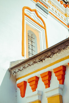 Building with orange and white detailing in a sunny location