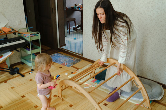 Mother and child assembling a play ladder at home