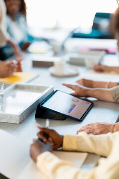 Business Team Meeting With Tablet and Charts
