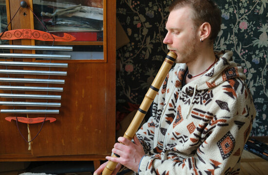Man playing a traditional Japanese shakuhachi flute