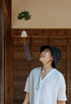 Summer Wind Chime and Smile: A Woman Listening to the Clear Sound