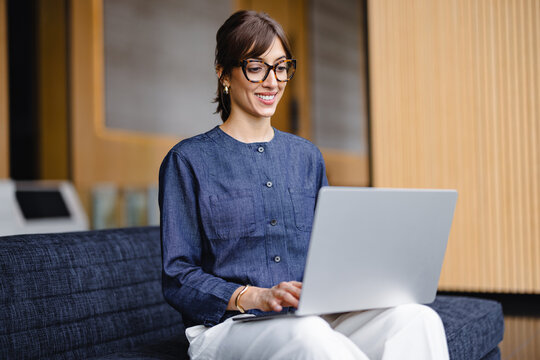 Woman Working on Laptop in Modern Office Setting