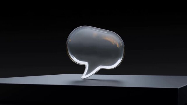 Reflective Speech Bubble Rotating on a Display Pedestal Against a Black Background