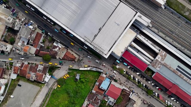Aerial view of Stasiun Kereta Cepat Padalarang with modern station architecture, surrounding residential rooftops, and nearby roads in Padalarang, West Java, Indonesia.