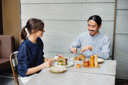 Couple Enjoys a Meal Together at a Restaurant in the City