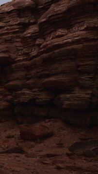 This scene features a rock formation in a canyon. The sunlight highlights the different textures and colors of the rock. The area is remote and natural, with no signs of human activity.