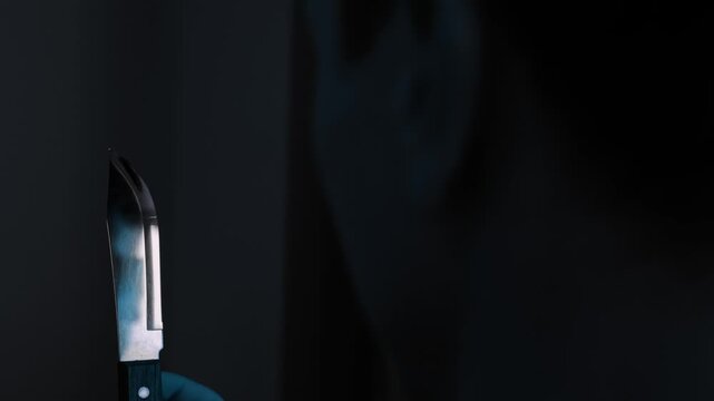 Knife standing in the foreground with a distressed man behind it, symbolizing suicidal thoughts, despair and dangerous inner struggle in a dark blue cinematic home interior with dramatic tension