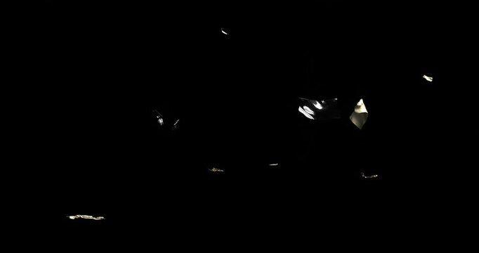 Black void starting foil fragments emerging, floating into layered gold-silver confetti cloud