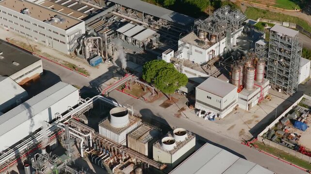Aerial view of industrial facility with large tanks and pipes at the Zona Industriale Piana di Montoro, Umbria, Italy.